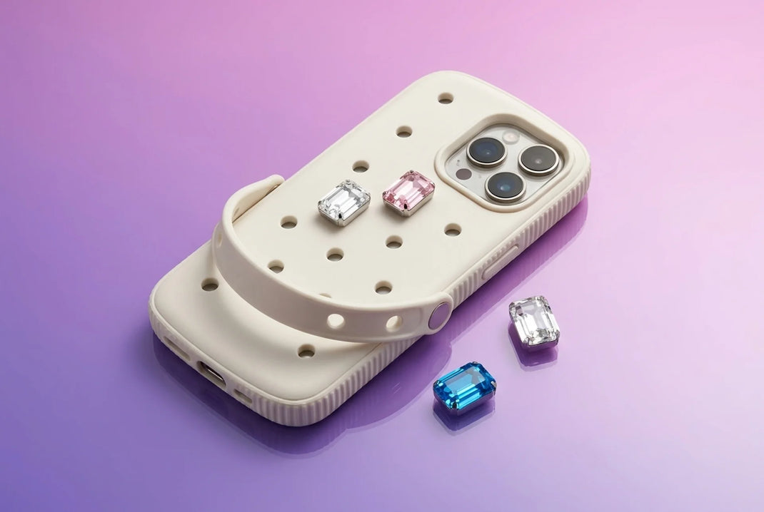 Phone case with loose gem charms nearby